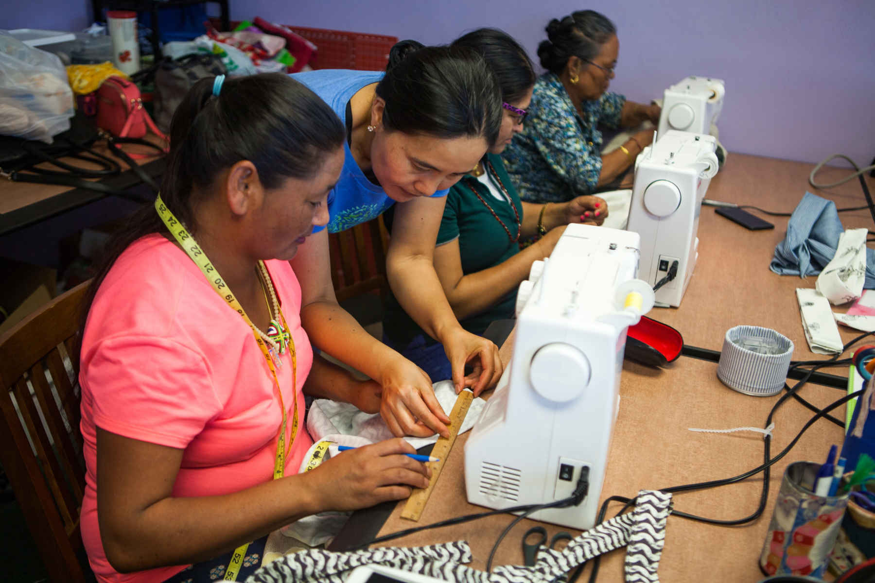 Master of Divinity alumni assists group of women in sewing workshop