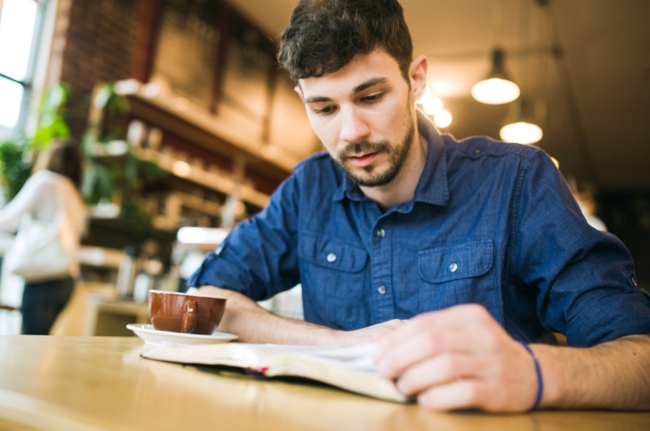 close up of a man reading a book, master of arts in theological studies, master of arts in theological studies online, masters in theology online