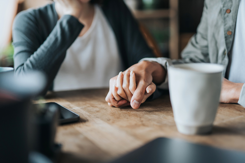 close up of two people holding hands